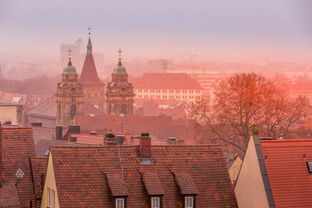 Aerial view of houses and cathedral towers in Nuremberg, Germany during foggy weather