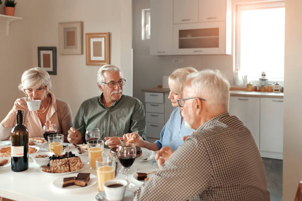 istock Senior Couples Enjoying Meal Together 1185090104