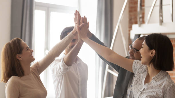istock Happy multiethnic business team engaged in teamwork give high five 1185095696
