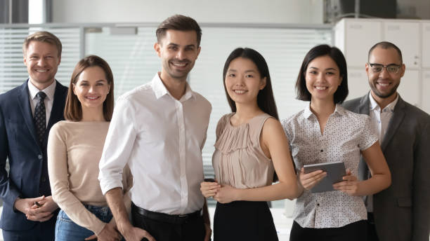 istock Happy diverse professional leaders looking at camera stand with employees 1185095707
