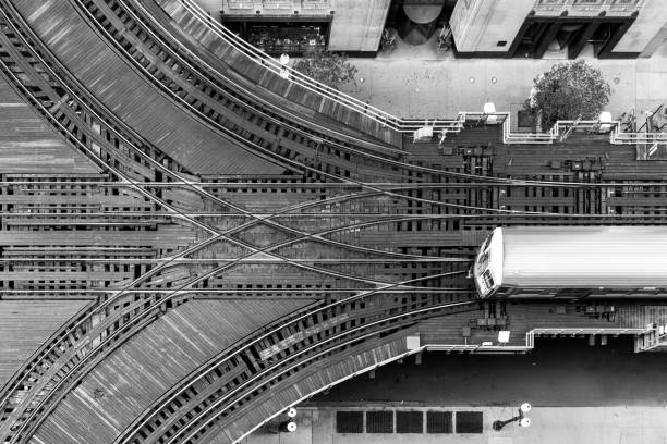 Chicago CTA "L" train and switch viewed from the top Black and white birds-eye photo of Chicago CTA "L" train approaching a switch. railroad track stock pictures, royalty-free photos & images