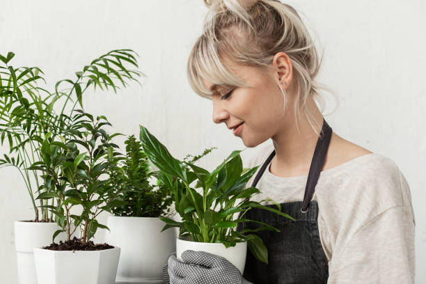 istock Young woman with plants 1185100727