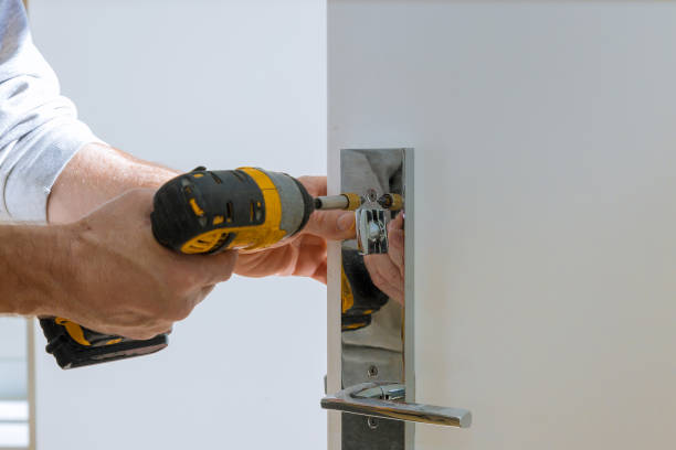 istock Carpenter fixing lock in door with home 1185101519
