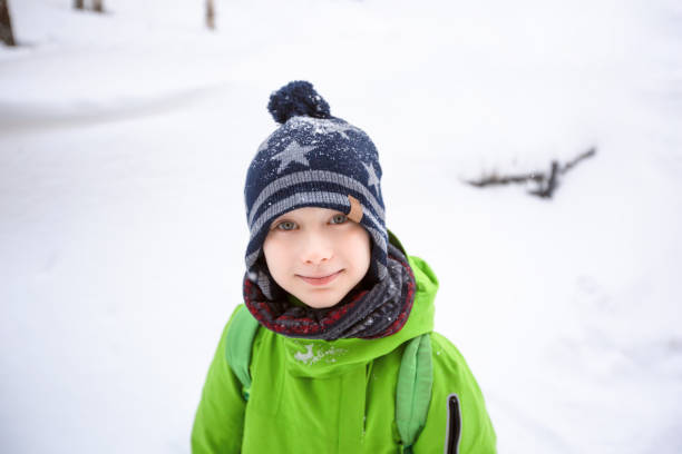 istock Little boy in colorful jacket and knitted hat 1185101594