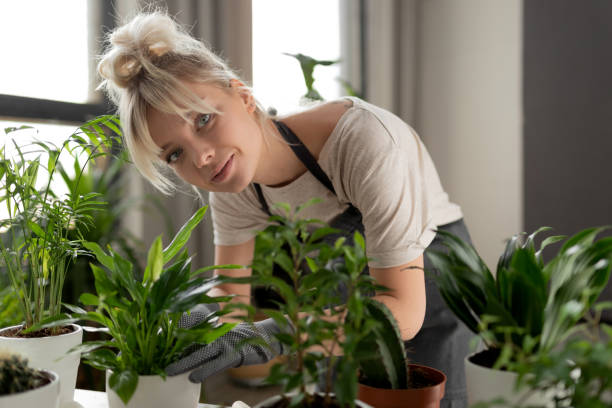 istock smiling girl with a tropical plant 1185101837