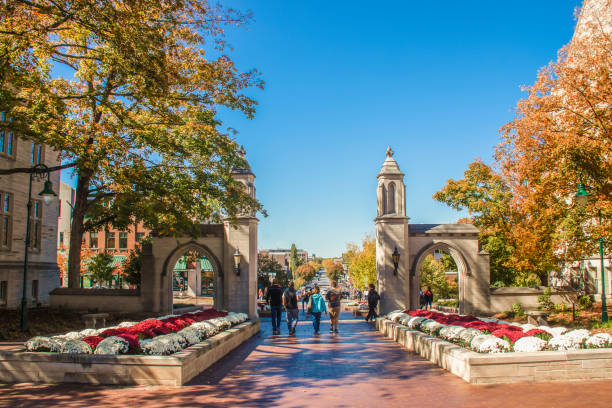 University of Indiana - Family walks with college student out main gates of campus down into the town during Fall Break weekend stock photo