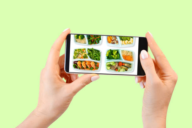 istock Woman hands holding smartphone with food delivery application. Isolated. 1185103404
