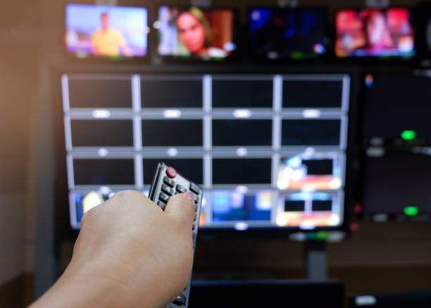 istock The woman's hand is using the remote control to press to watch the program on television. 1185106597
