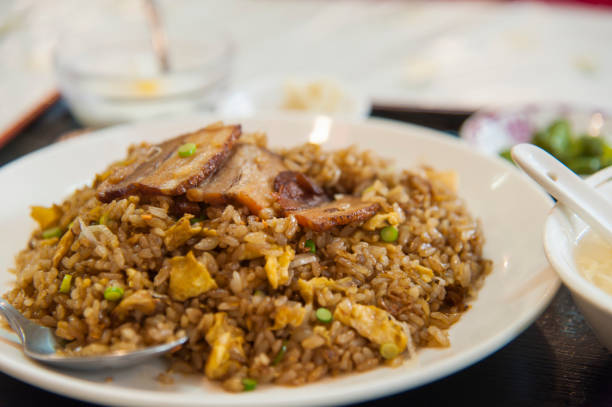 Fried rice Fried rice is Chinese food made with typical rice, stir-fried together with ingredients. chinese cuisine fried rice asian cuisine wok stock pictures, royalty-free photos & images