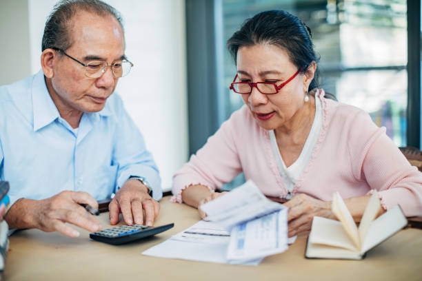 istock Senior couple doing finances at home 1185108986