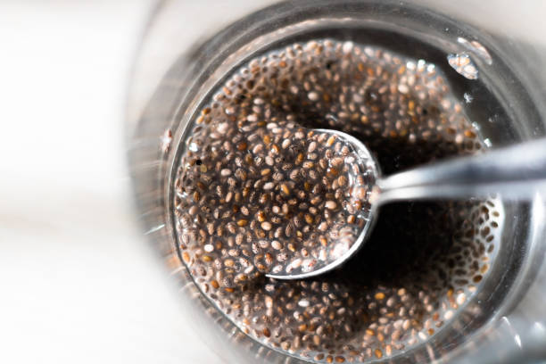 Top view on glass containing chia seeds gel Top view on glass containing chia seeds gel with partially submerged spoon. chia seed stock pictures, royalty-free photos & images