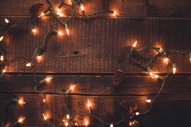 istock Christmas Lights on dark Wood 1185114344