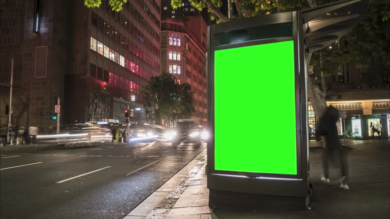 City street Billboard stand with green screen. Time lapse with commuters, people and cars. Space for text or copy.