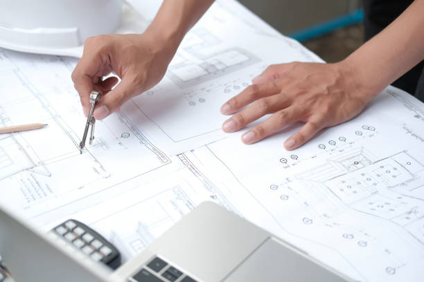 istock architect engineer working on house blueprint of real estate project. building construction concept 1185122039