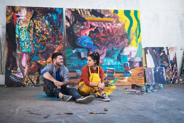 istock Young couple artist painting in studio. 1185122266