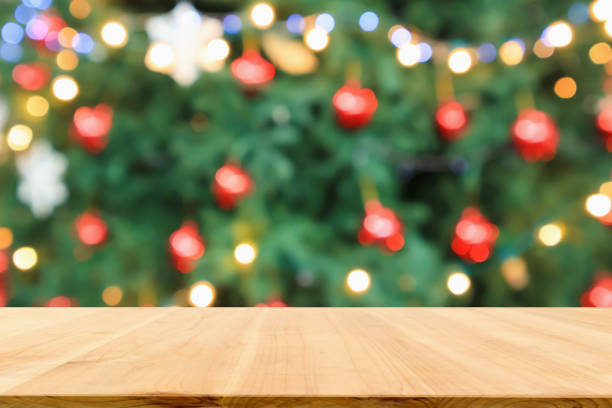 istock Empty wood table top with Abstract blur Christmas tree with decoration bokeh light background for product display 1185127072