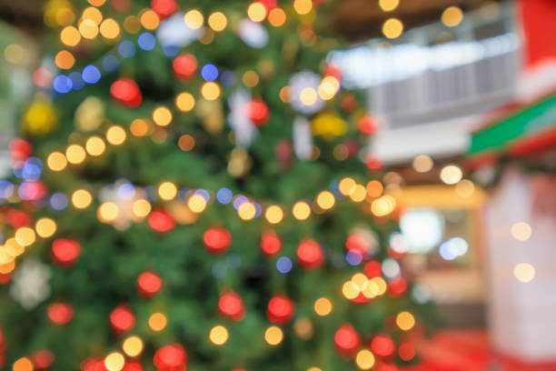 istock Abstract christmas holiday with festive gold bokeh light on tree blurred background 1185127073