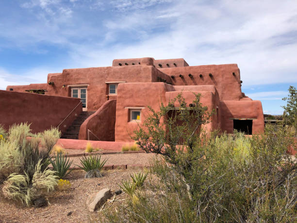 The Painted Desert Inn Holbrook, Arizona, USA - September 24, 2019: In its almost 100 years overlooking the Painted Desert, the inn has undergone many changes. The original structure, built from petrified wood by Herbert David Lore in the early 1920s was operated as a tourist attraction. Visitors could eat meals and the inn had six small rooms to accommodate overnight guests. In the 1930’s the property was purchased by Petrified Forest National Monument and the building was rebuilt by the Civilian Conservation Corp. In 1940 the inn was reopened for meals, souvenirs and lodging. Once again during World War II the inn was closed. After the war, the inn was taken over and operated by the Fred Harvey Company. The company’s famed architect, Mary Colter, redesigned the building to give it a Southwestern look which is maintained today. The building was registered as a national historic landmark in 1987 and now serves only as a museum with no overnight accommodation and food service. The Painted Desert Inn is located on Kachina Point in Petrified Forest National Park near Holbrook, Arizona, USA. jeff goulden petrified forest national park stock pictures, royalty-free photos & images