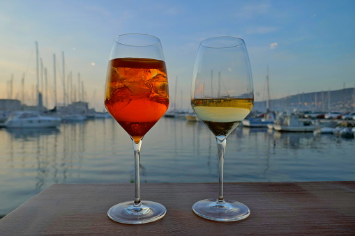 Waiting for the sunset while enjoying an aperitif with your partner. A pleasant evening in Italy