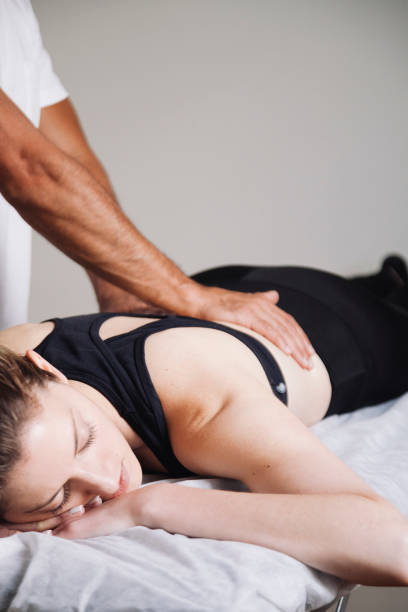 istock physiotherapist working with patient in clinic 1185133202