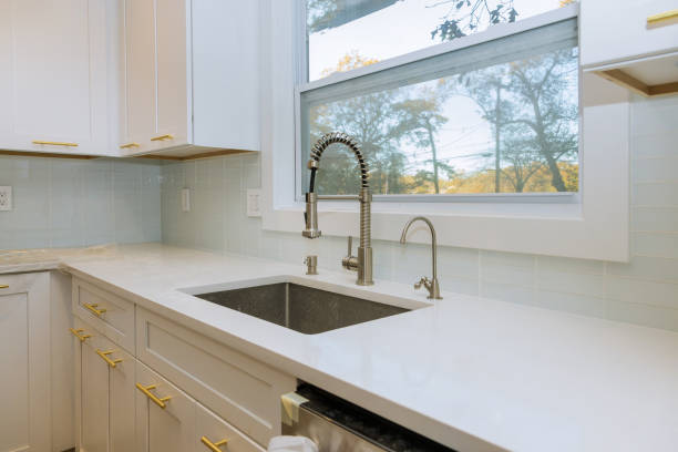 istock Stainless steel kitchen sink and window centered in a kitchen 1185139103