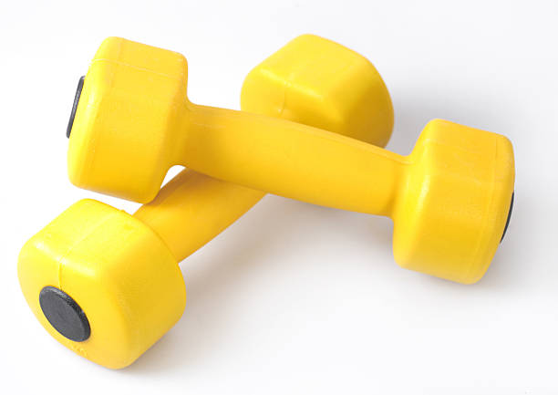mancuernas - gym yellow muscular build dumbbell fotografías e imágenes de stock