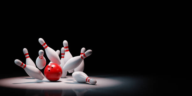 istock Bowling Strike of Skittles Spotlighted on Black Background 1185140220