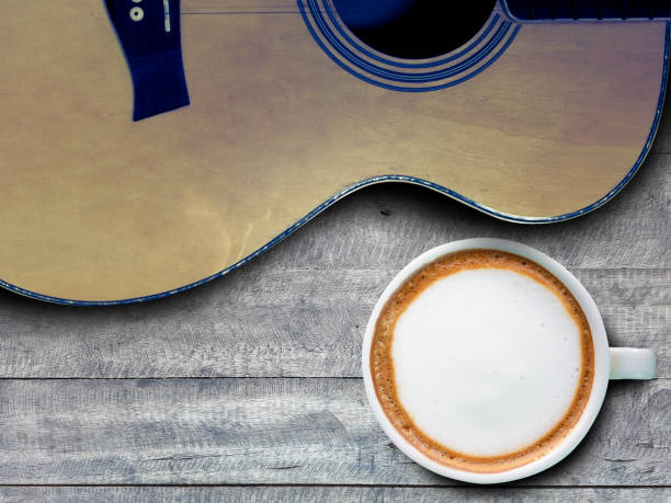 coffee and guitar on wooden table. (with free space for text)
