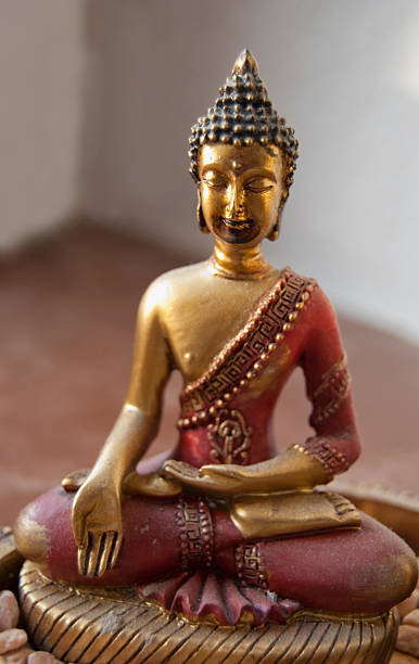 meditating red buddha stock photo