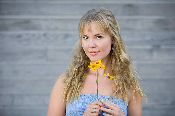 istock Beautiful Woman Holding Flowers 118515582