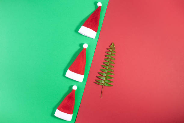 istock Santa claus hat on geometric red and green background. 1185159175