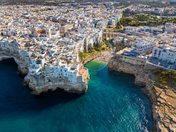 Polignano A Mare, Apulia, Italy Aerial view of Polignano a Mare town and beach in Bari Province, Puglia, Italy puglia beach stock pictures, royalty-free photos & images