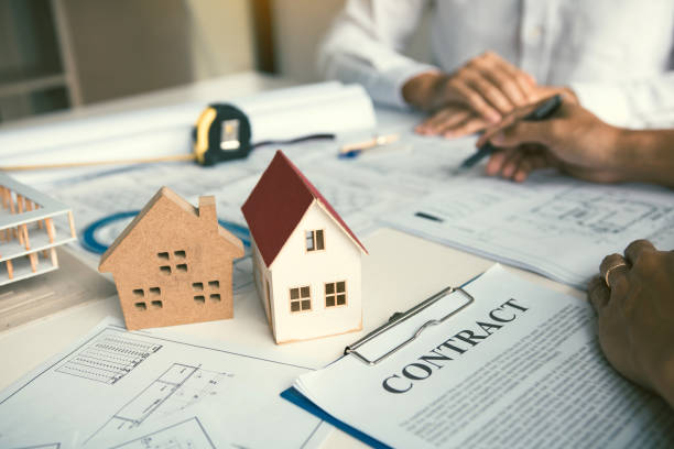 istock Architect working on blueprint discussing new project with colleague in office. 1185167409