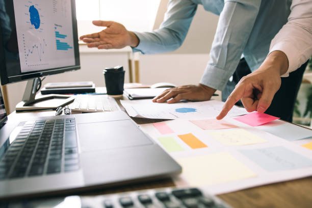 istock Two business partnership working on project with new startup and discussion working together in modern office. 1185167600