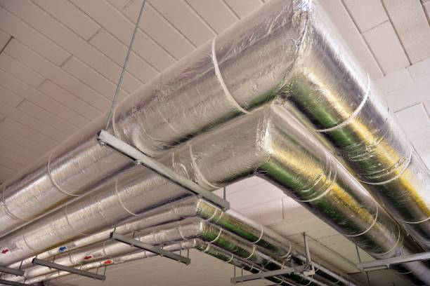istock Water pipes and cable trays run under ceiling of a building 1185168467