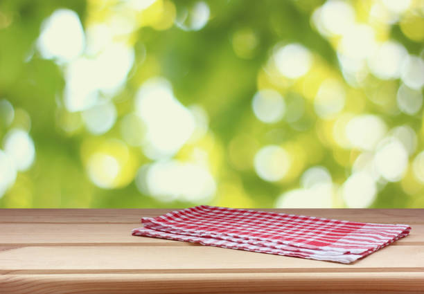 istock empty kitchen table with a towel on a blurred green background of nature. 1185168536