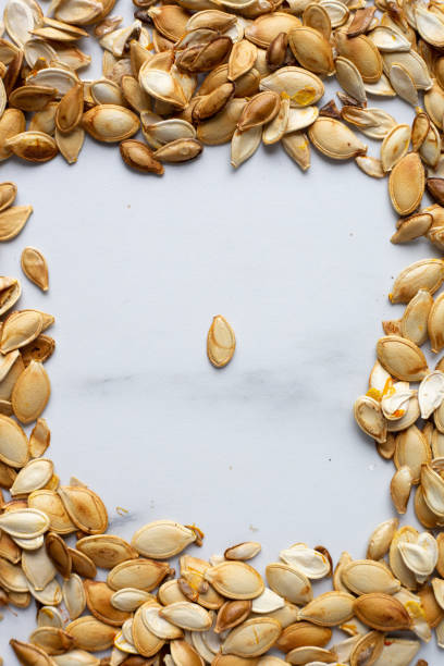 istock roast Pumpkin seeds background, flat lay 1185168891