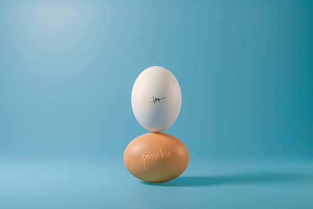 Impossible of two eggs stack on a light blue background with possible word. Minimal creative idea concept. Realistic 3D render. Impossible of two eggs stack on a light blue background with possible word. Minimal creative idea concept. Realistic 3D render. impossible possible stock pictures, royalty-free photos & images
