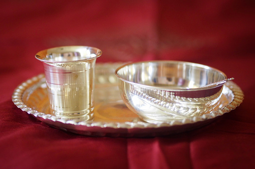 Picture of a set of silverware comprising of silver plate, silver glass and silver bowl