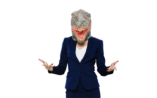 One person / front view / looking at camera of 20-29 years old adult beautiful black hair / long hair latin american and hispanic ethnicity female / young women businesswoman / business person standing wearing skirt / businesswear / blazer - jacket / jacket / mask - disguise / costume / a suit who is humor / wearing dinosaur mask