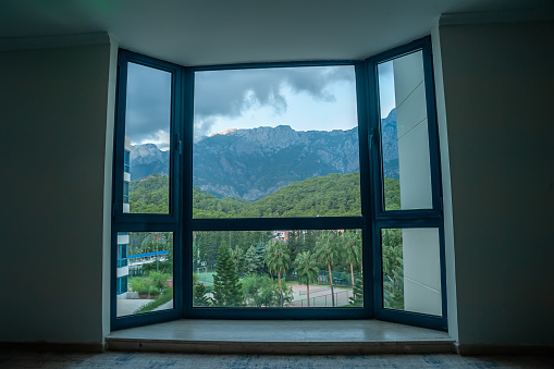 Panoramic window overlooking the forest and mountains
