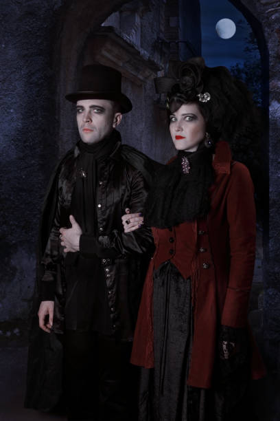 istock The sinister young couple dressed in vampire style clothes 1185184466