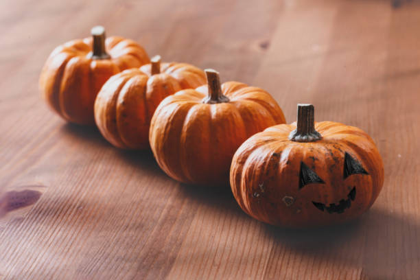 istock Pile of Pumpkins on Wooden Table 1185184782