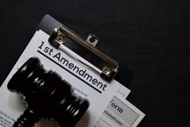 Photo of 1st Amandment text on Document and gavel isolated on office desk. Law concept