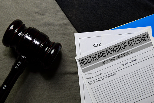 Healthcare Power Of Attorney text on Document and gavel isolated on office desk. Law concept