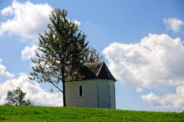 istock Chapel in Germany on green field with blue sky 1185186123