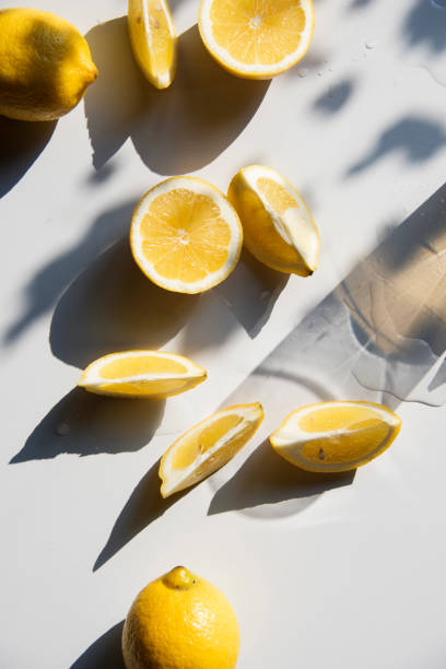 istock Fresh lemon slices on a table with trendy artistic shadows in the morning sunlight. 1185189808