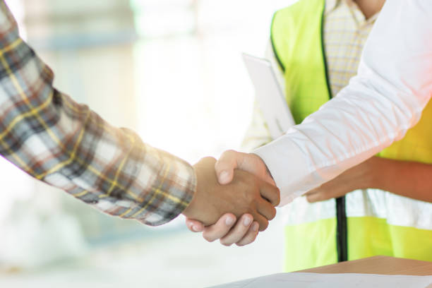 istock Close up engineer shaking hand with building contractor in construction site , successful negotiate of manager and industrial agreement cooperation concept 1185189970