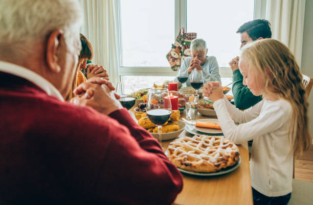 istock Multi-generation family doing prayer over Christmas table 1185192866