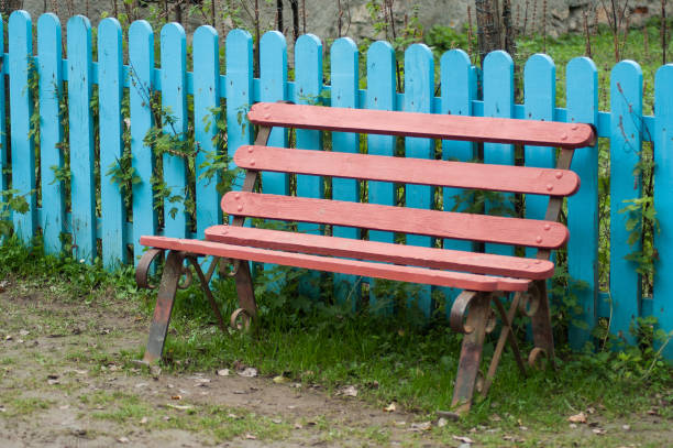 istock pink wooden bench in a garden 1185194951